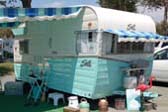 Classic 1962 Shasta Airflyte Travel Trailer With Striped Side and Window Awnings